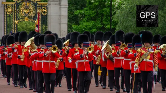 Guards marching in ceremonial uniform outside Buckingham Palace.